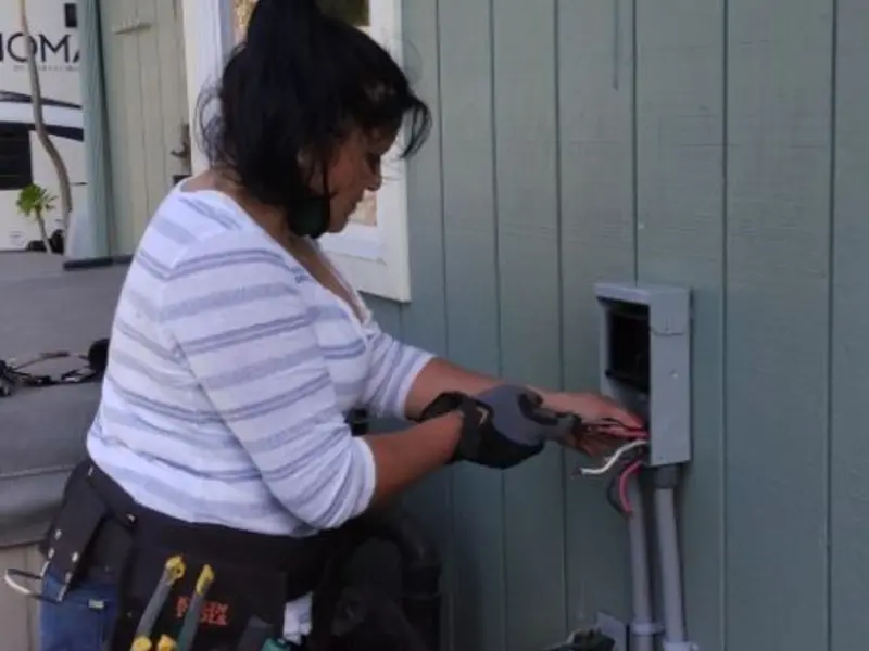 Licensed electrician wiring an exterior subpanel in Portola Valley